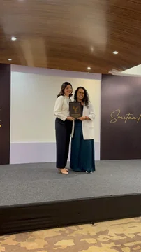 Dhvani Shah receiving an award on stage
